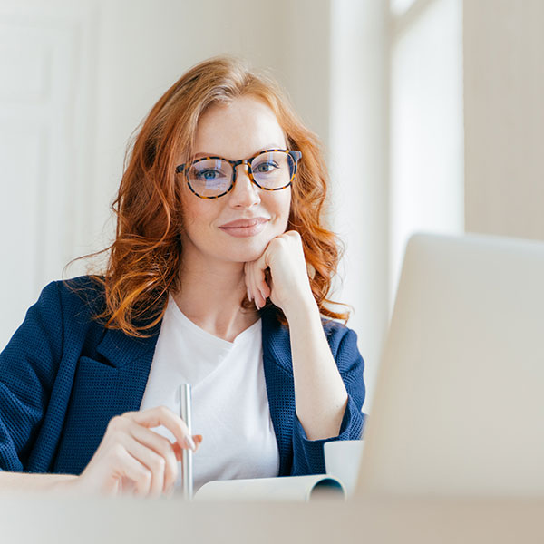woman wearing glasses working