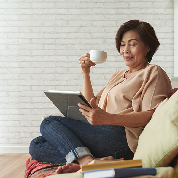 mature woman reading on her couch
